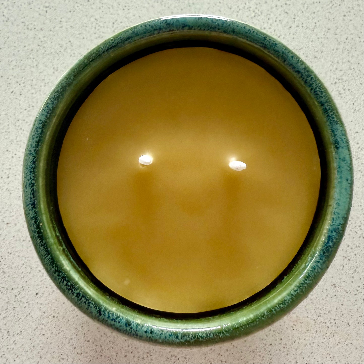 “Emerald Ember” pure beeswax candle in local pottery